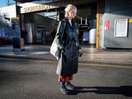 location portrait of young woman in urban environment in front of train statio natural light speedlight 