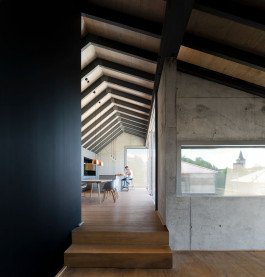 interior photography of kitchen with sloped wooden roof and beams 