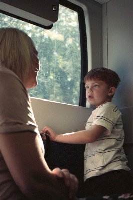 portrait of young kind and mother on train 